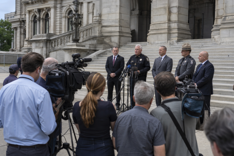 Editorial illustration for New York Sheriffs Sue Over ICE-Agreement Ban as Hochul Vows Enforcement