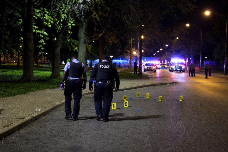 Editorial illustration for Ten Shot Near Washington Park as Chicago Police Hunt for Answers After Deadly Crowd Shooting